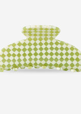 A green and white checkered claw hair clip on a light gray background.