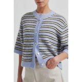 Person wearing a striped cardigan with a light blue collar and sleeves.