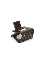A glossy dark brown hair claw clip shown from a three-quarters angle on a clean white background.