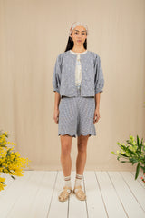 Woman wearing a light blue outfit with a beige background