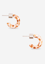 A pair of small hoop earrings with a warm orange and white leopard print pattern, featuring silver-tone posts and backings, set against a light gray background.