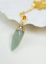 Necklace with a green pendant on a white background