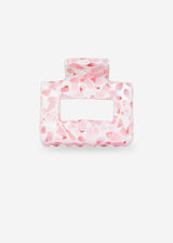 Pink and white marbled hair tie on a white background