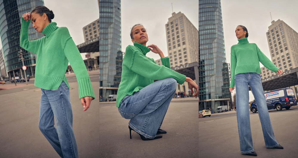 Women in green rollneck jumper and jeans in the city