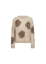A beige knit sweater featuring large brown and black floral motifs woven across the front and sleeves, displayed on a solid white background.
