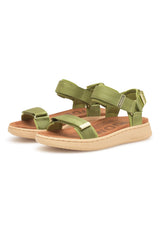 Green sandals with beige soles on a white background