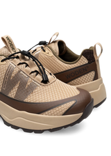 Pair of brown and beige hiking shoes on a white background