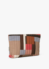 A quilted rectangular pouch with a multicolor patchwork design of vertical stripes in brown, beige, pink, orange, and light blue, shown on a plain white background.