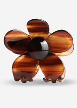 Brown flower-shaped object on a light gray background