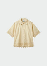 A pale yellow short-sleeve button-up shirt with delicate lace trim on the collar, cuffs, and hem, displayed against a light gray background.