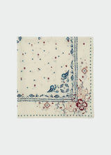 An off-white bandana featuring a classic paisley pattern in blue, red, and green, with embroidered corner details, shown flat against a light gray background.
